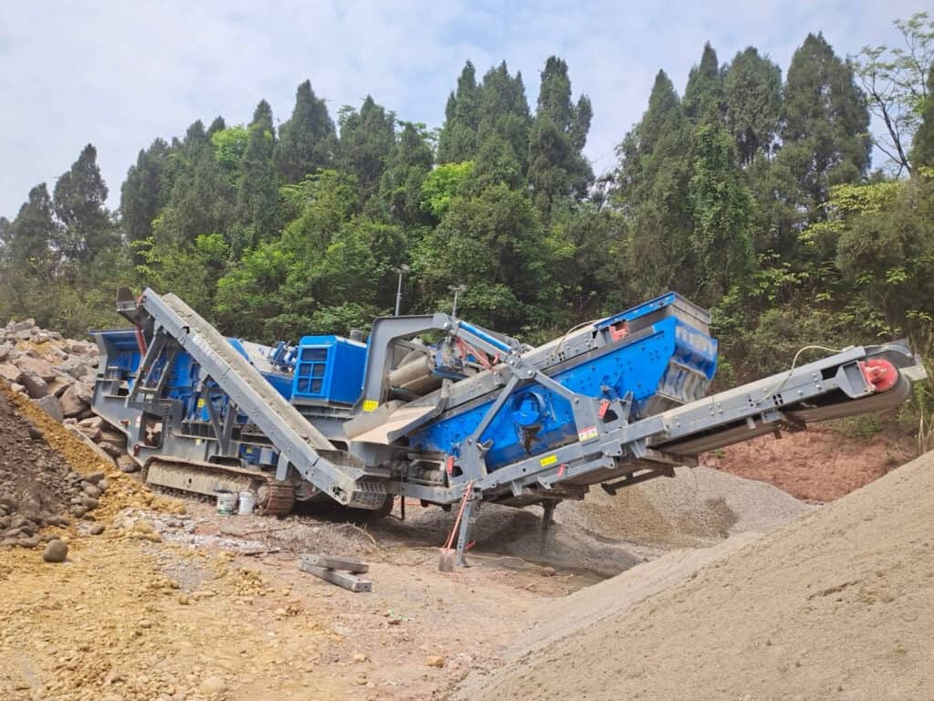 XCRUSHER XC1213 crawler mobile impact crusher in the process of crushing concrete blocks